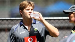 Support staff look on nervously as Watson tries to drink a bottle of water without injuring himself.