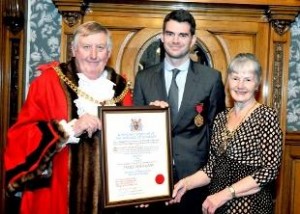 Jimmy Anderson picks up his certificate confirming him Burnley's second sexiest person.